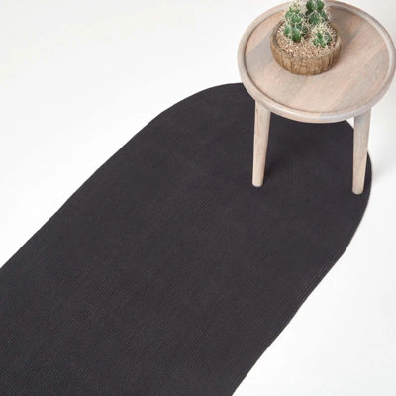 Image of Homescapes Black Handmade Woven Braided Oval Rug, 66 X 200 Cm